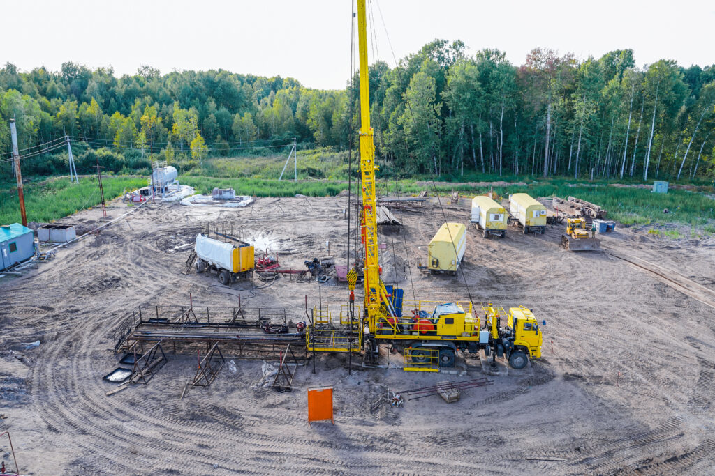 Sector Insights special equipment for drilling an oil well in an oil field. workover rig working on a previously drilled well trying to restore production through repairin a row are oil producing wells.