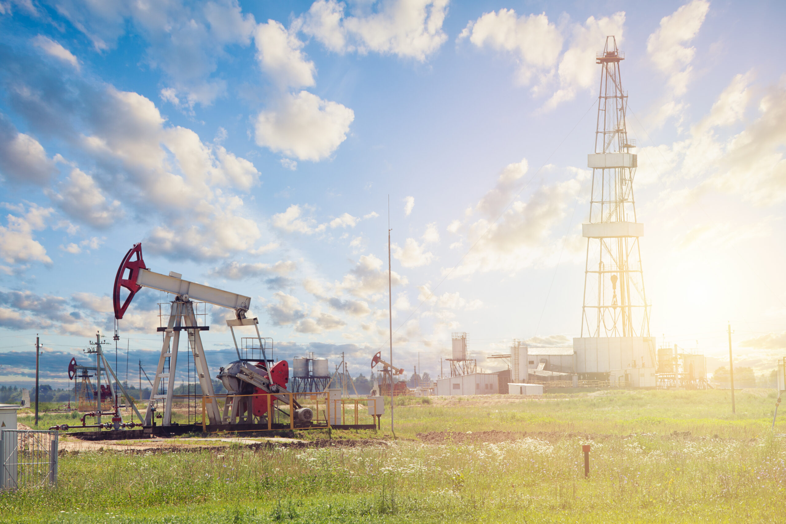 Home oil pump jack. pumpjack against sky clouds